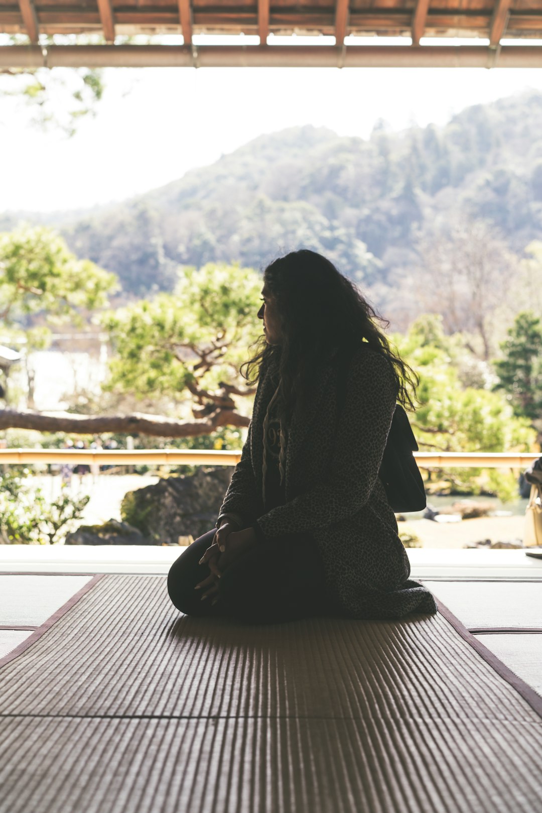 woman-in-black-and-white-striped-dress-sitting-on-brown-wooden-floor-during-daytime-cehwph-z2s8